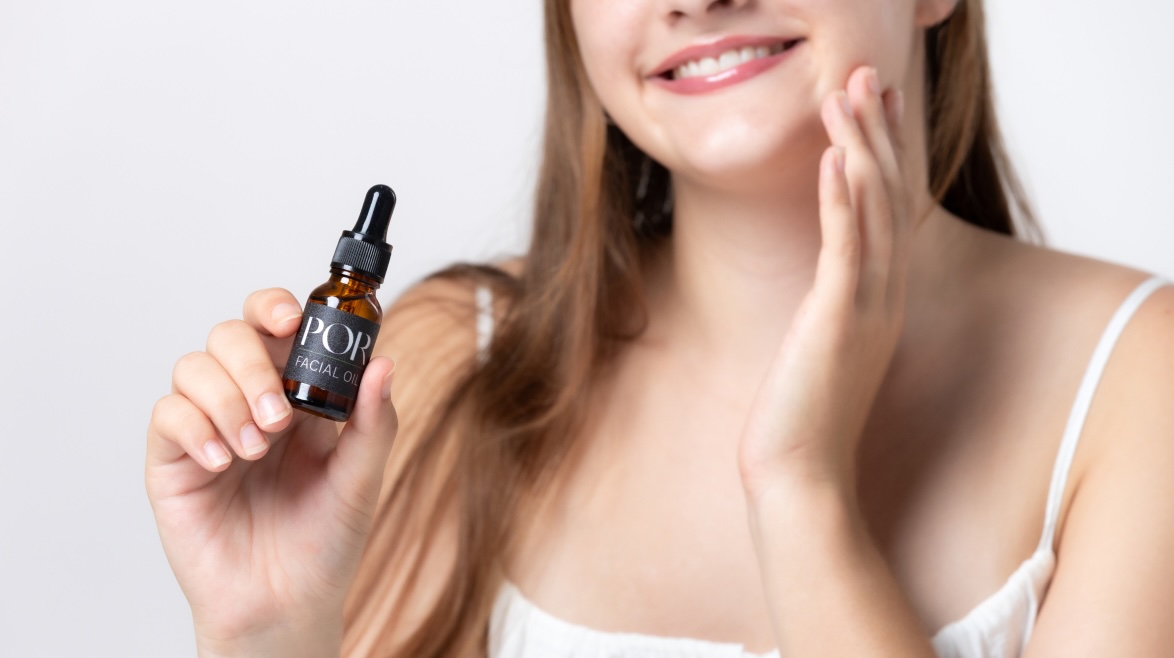 Woman with facial oil dropper